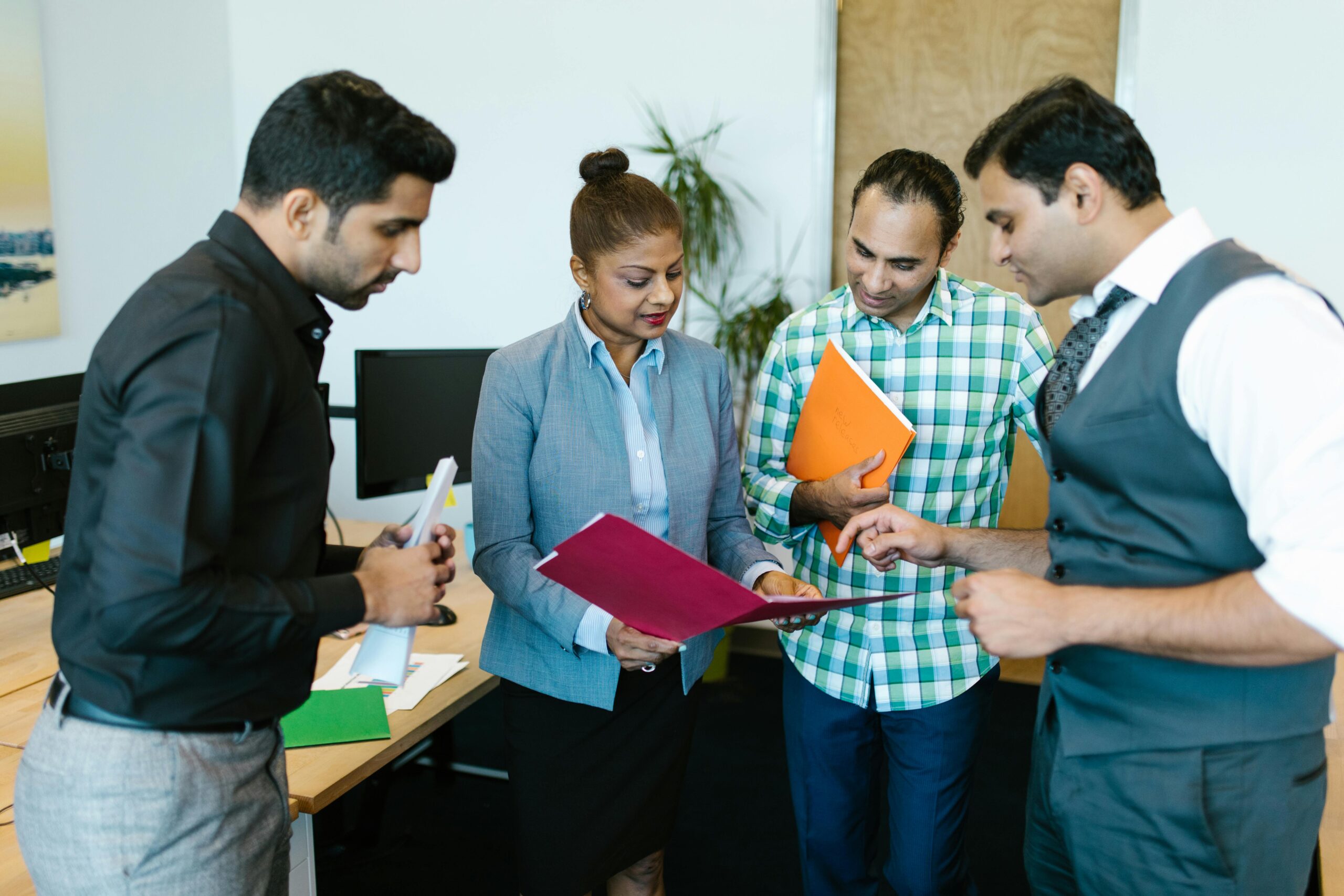 Business team engaged in discussion during a meeting in a modern office setting.